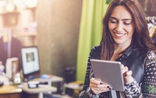 Small business owner checking information on a tablet