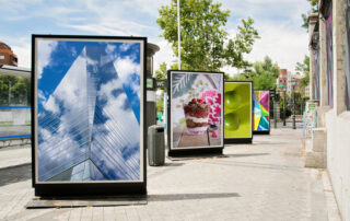 4 billboards with photographs exhibited at city street for display advertising